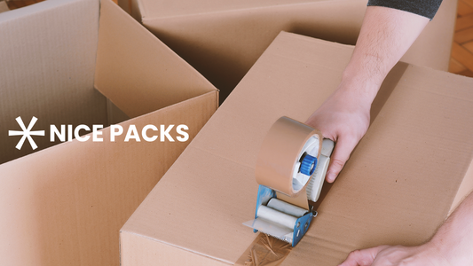 person taping cardboard box