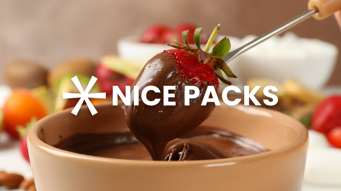 hand dipping strawberry in bowl full of chocolate