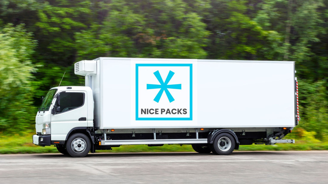 A white truck and trailer with the Nice Packs logo on the trailer